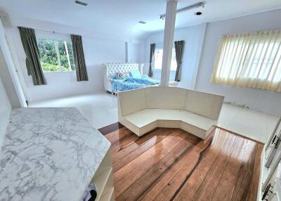 Spacious bedroom with marble table, couch, and bed