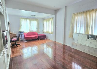 spacious living room with wooden flooring and large windows