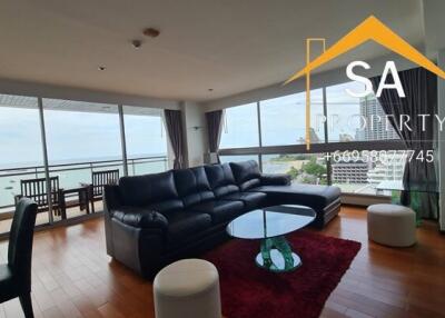 Spacious living room with sea view, modern furnishings, and wooden floor