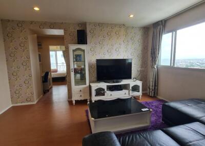 Modern living room with large window and TV area