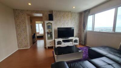 Modern living room with large window and TV area