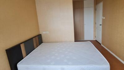 Empty bedroom with mattress and wardrobe