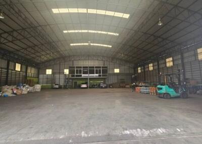 Spacious warehouse interior with high ceiling and storage areas