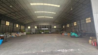 Spacious warehouse interior with high ceiling and storage areas