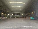 Spacious warehouse interior with high ceiling and storage areas