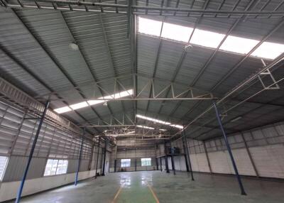 Spacious warehouse interior with high ceilings and skylights