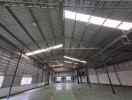 Spacious warehouse interior with high ceilings and skylights