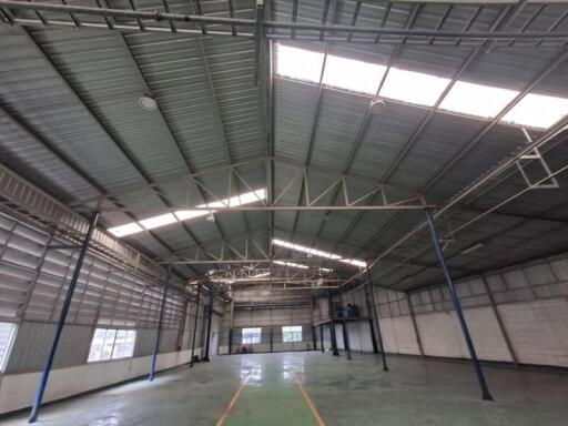 Spacious warehouse interior with high ceilings and skylights