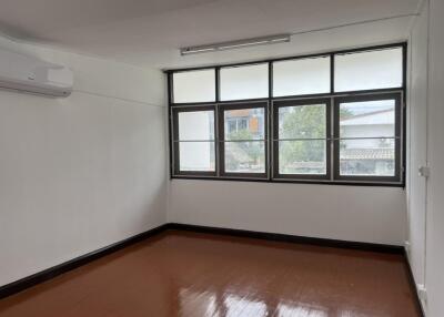 Well-lit bedroom with large windows and air conditioning