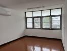 Well-lit bedroom with large windows and air conditioning