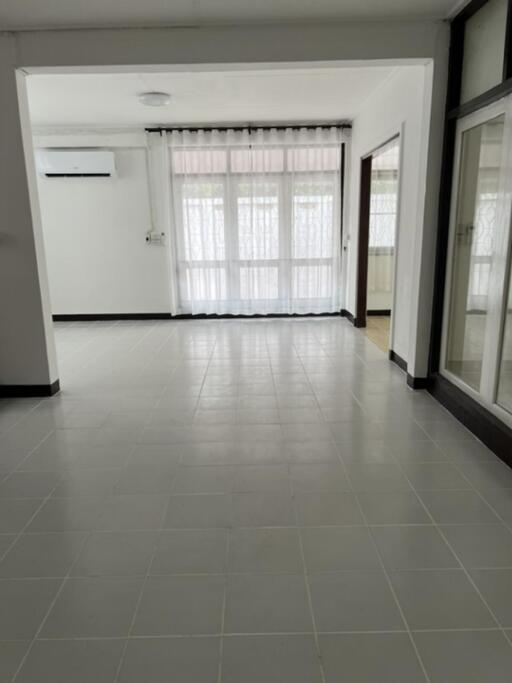 Spacious main living area with large windows and natural light