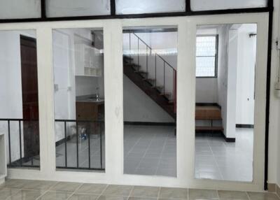 Living area with tiled floor and staircase