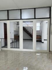 Living area with tiled floor and staircase