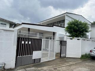 Front view of a modern house with a gated entrance