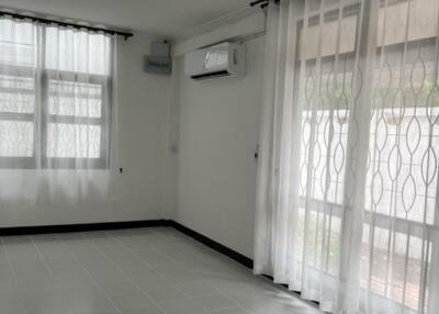 Bright living room with large windows and tile flooring