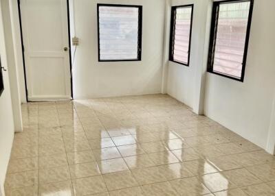 Empty room with tiled floor and multiple windows