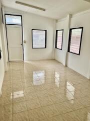 Empty room with tiled floor and multiple windows