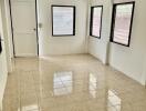 Empty room with tiled floor and multiple windows