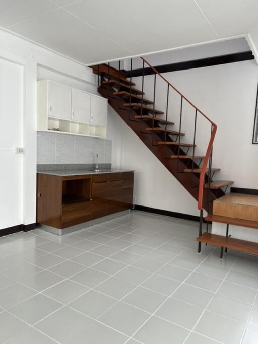 Modern kitchen with wooden staircase