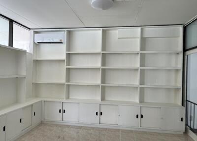 Room with white built-in shelves and cabinets