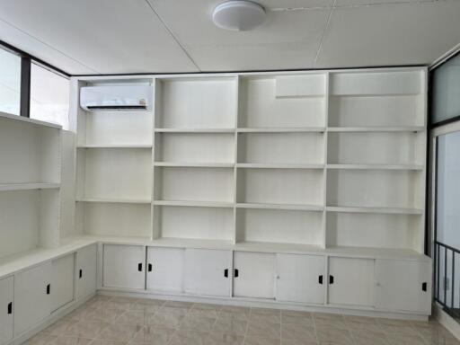 Room with white built-in shelves and cabinets