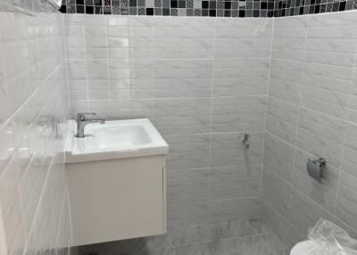 Bathroom with white and grey tiling