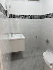 Bathroom with white and grey tiling