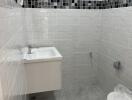 Bathroom with white and grey tiling