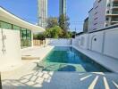 Modern outdoor swimming pool area with surrounding buildings