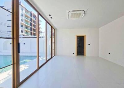 Spacious living room with large windows and pool view