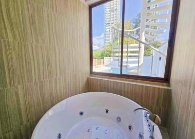 Bathroom with large jacuzzi and window view