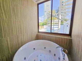 Bathroom with large jacuzzi and window view