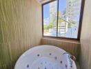 Bathroom with large jacuzzi and window view