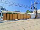 Front view of a modern house with a large wooden gate