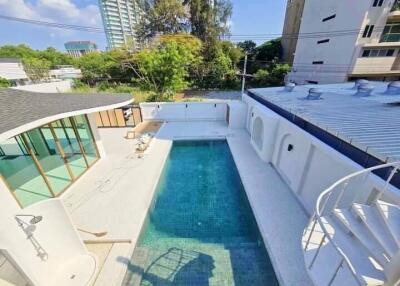 Outdoor area with swimming pool and modern architectural features