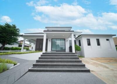 Front view of a modern house with steps leading to the entrance