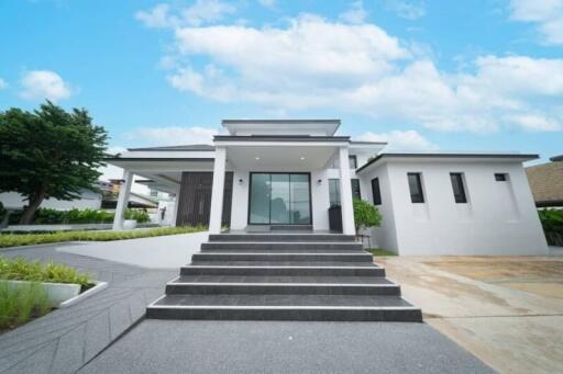 Front view of a modern house with steps leading to the entrance