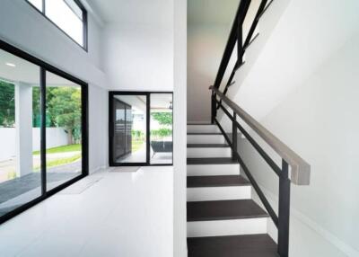 Modern living area with large windows and staircase