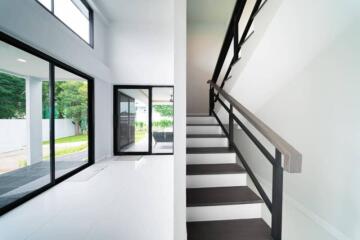 Modern living area with large windows and staircase