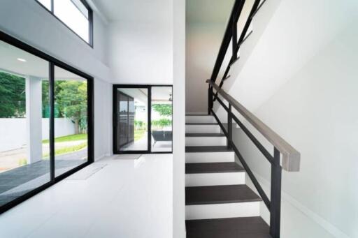 Modern living area with large windows and staircase