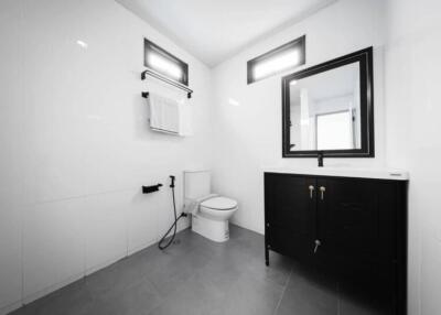 Modern bathroom with black vanity and white tiles