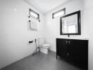 Modern bathroom with black vanity and white tiles