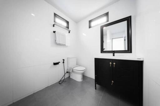 Modern bathroom with black vanity and white tiles