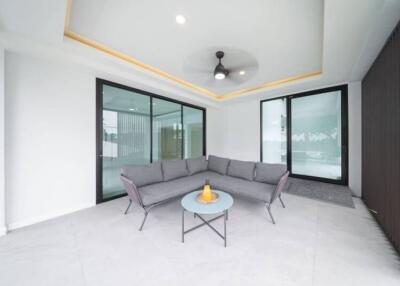 Modern living area with a grey sofa and a glass table