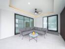 Modern living area with a grey sofa and a glass table