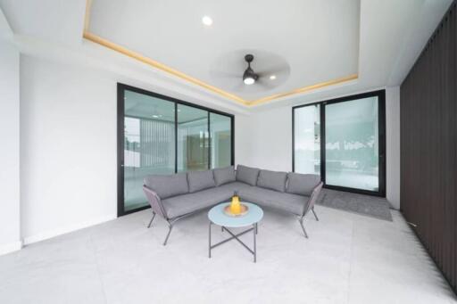 Modern living area with a grey sofa and a glass table