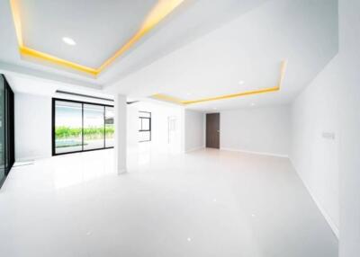 Spacious and modern living area with large windows and recessed lighting