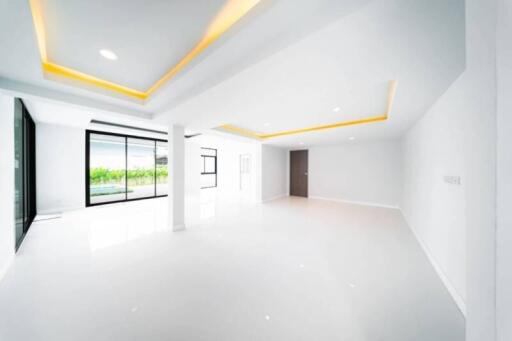 Spacious and modern living area with large windows and recessed lighting