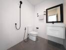 Modern bathroom with white tiles, black fixtures, and a floating vanity