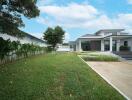 Exterior view of a modern house with a lawn and driveway